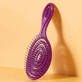 Ninabella Detangler Brush in a stylish bathroom setting