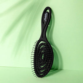 Ninabella Detangler Brush on a bathroom counter