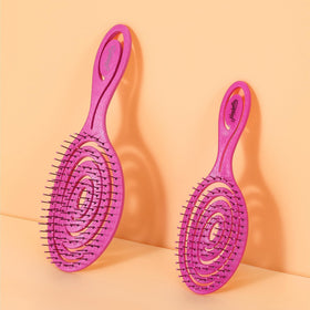 Ninabella Mini Detangler Brush on a bathroom counter