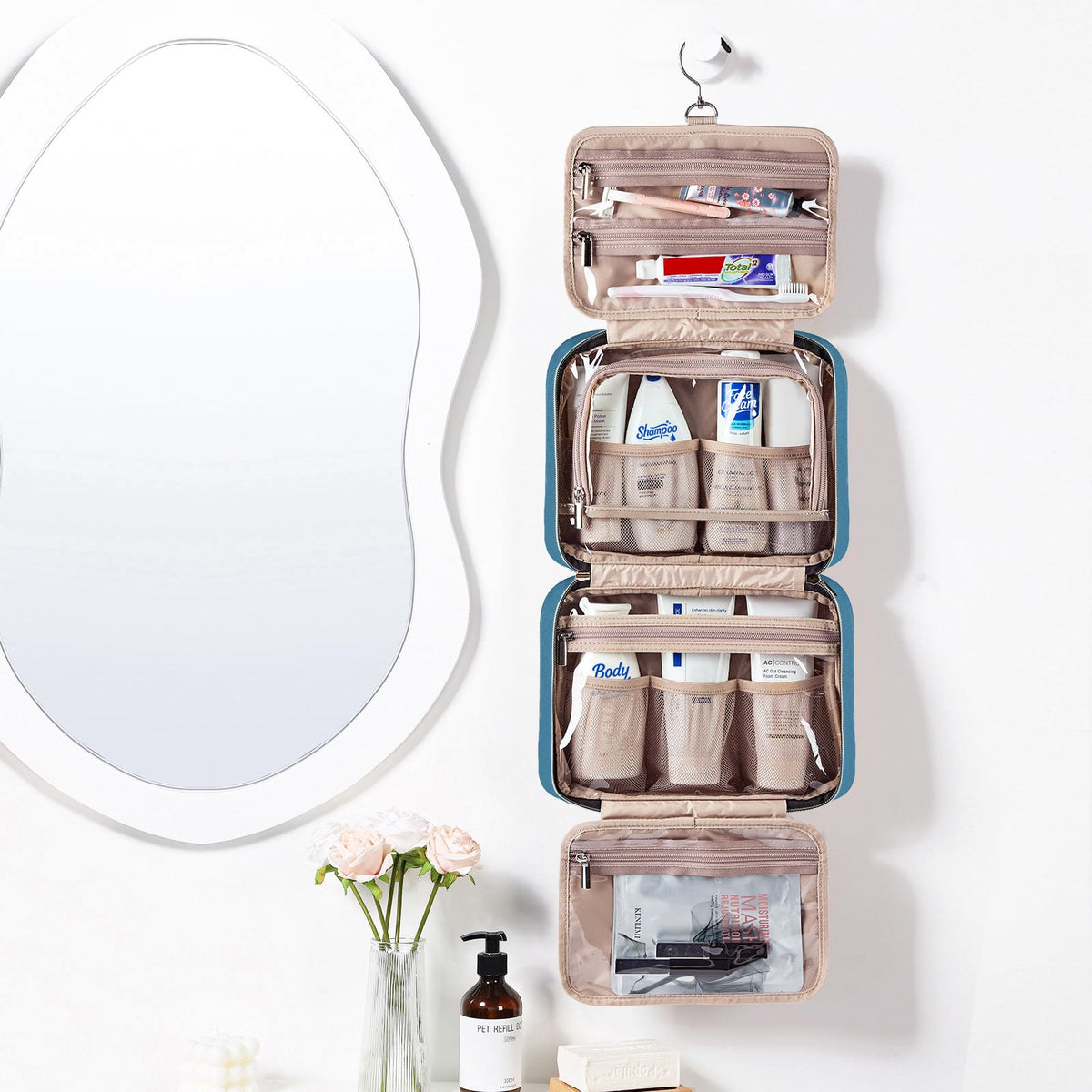 NISHEL Travel Toiletry Bag open showing four compartments