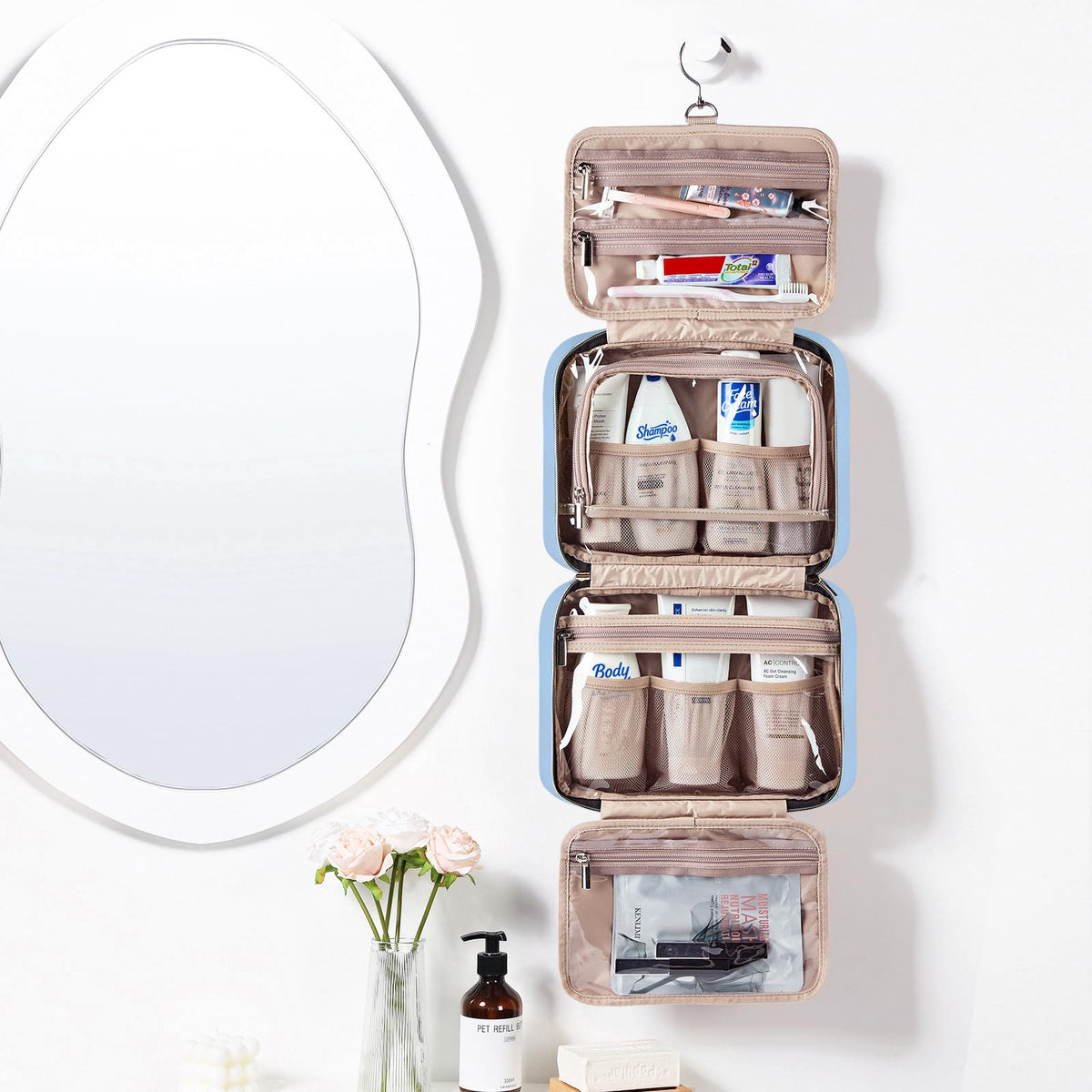 NISHEL Travel Toiletry Bag opened showing four compartments