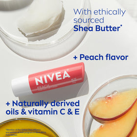 NIVEA Peach Lip Care tinted lip balm on a wooden table