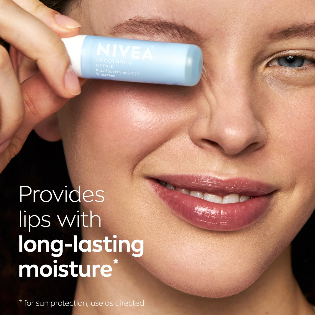 NIVEA Smoothness Lip Care SPF 15 balm on a wooden table