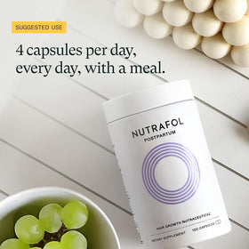 Nutrafol Postpartum Hair Growth Supplements displayed with a plant