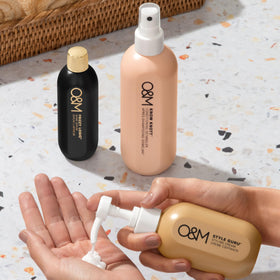 O&M Frizzy Logic Serum 50ml lifestyle scene on a bathroom shelf