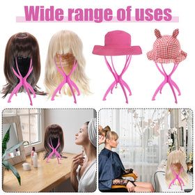 obeoby Pink Wig Stand holding a hat