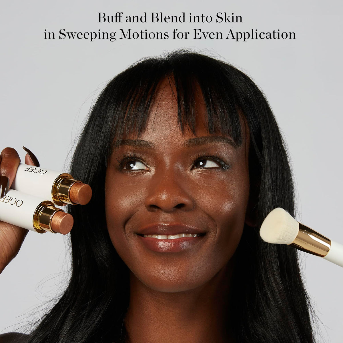 Ogee Blender Brush in hand demonstrating makeup application