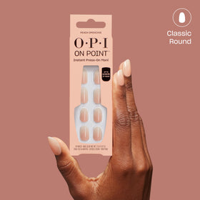 OPI On Point Peach Smoochie nails in a lifestyle setting