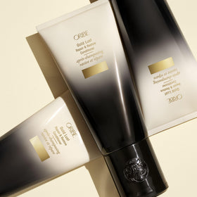 ORIBE Gold Lust Conditioner bottle with nature backdrop