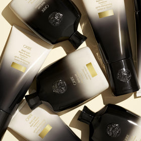ORIBE Gold Lust Shampoo on a wooden surface