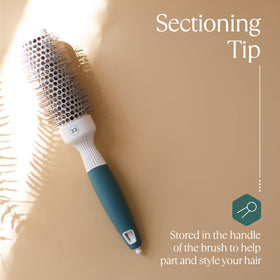 Osensia Round Brush beside hair care products