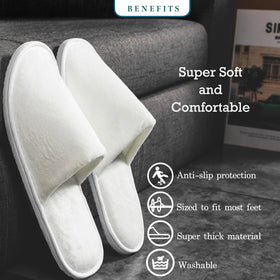 OSTADARRA spa slippers displayed on a hotel bed