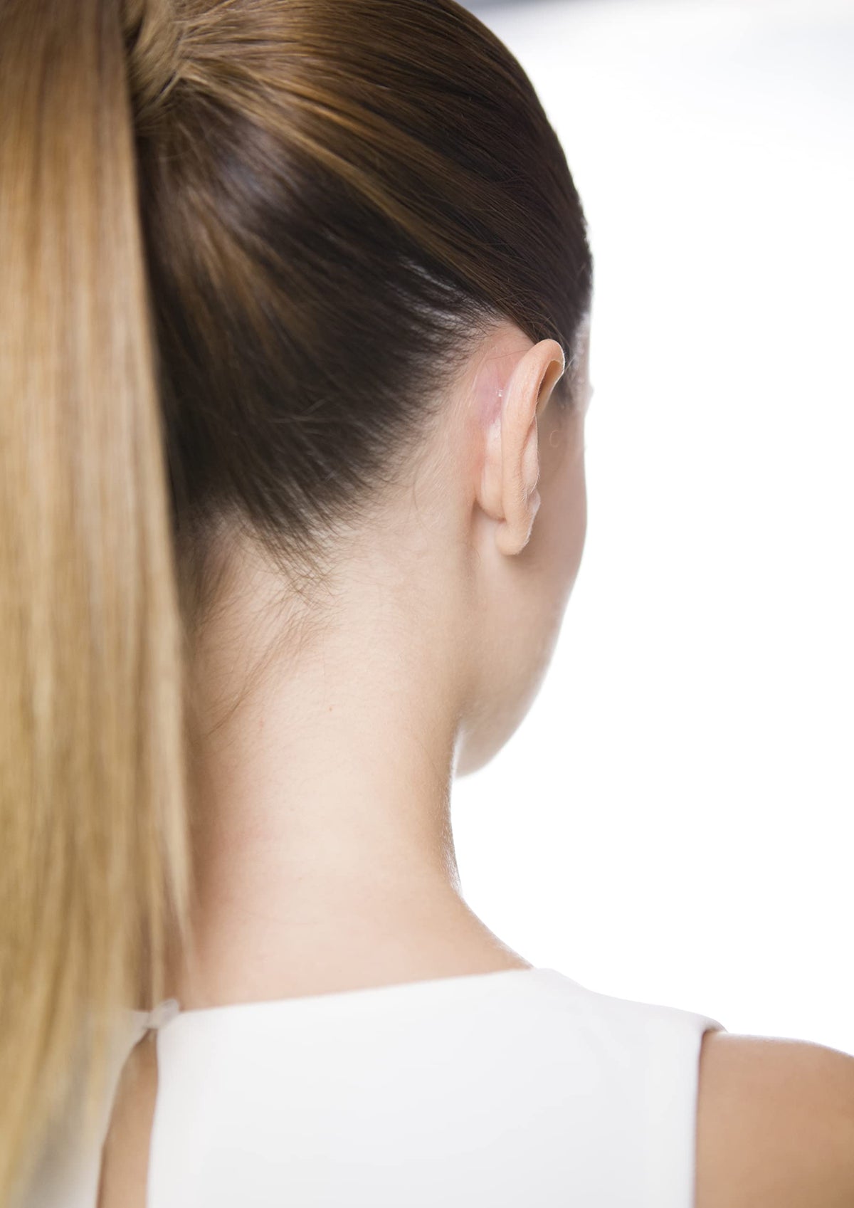 Otostick Ear Corrector in use during a social event