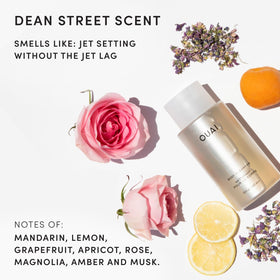 OUAI Body Cleanser in a bathroom setting with towels