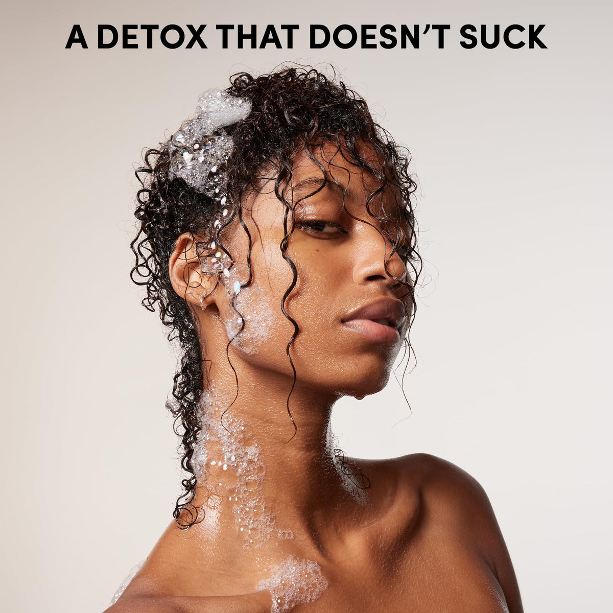 OUAI Detox Shampoo 32 oz with lathered hair in shower