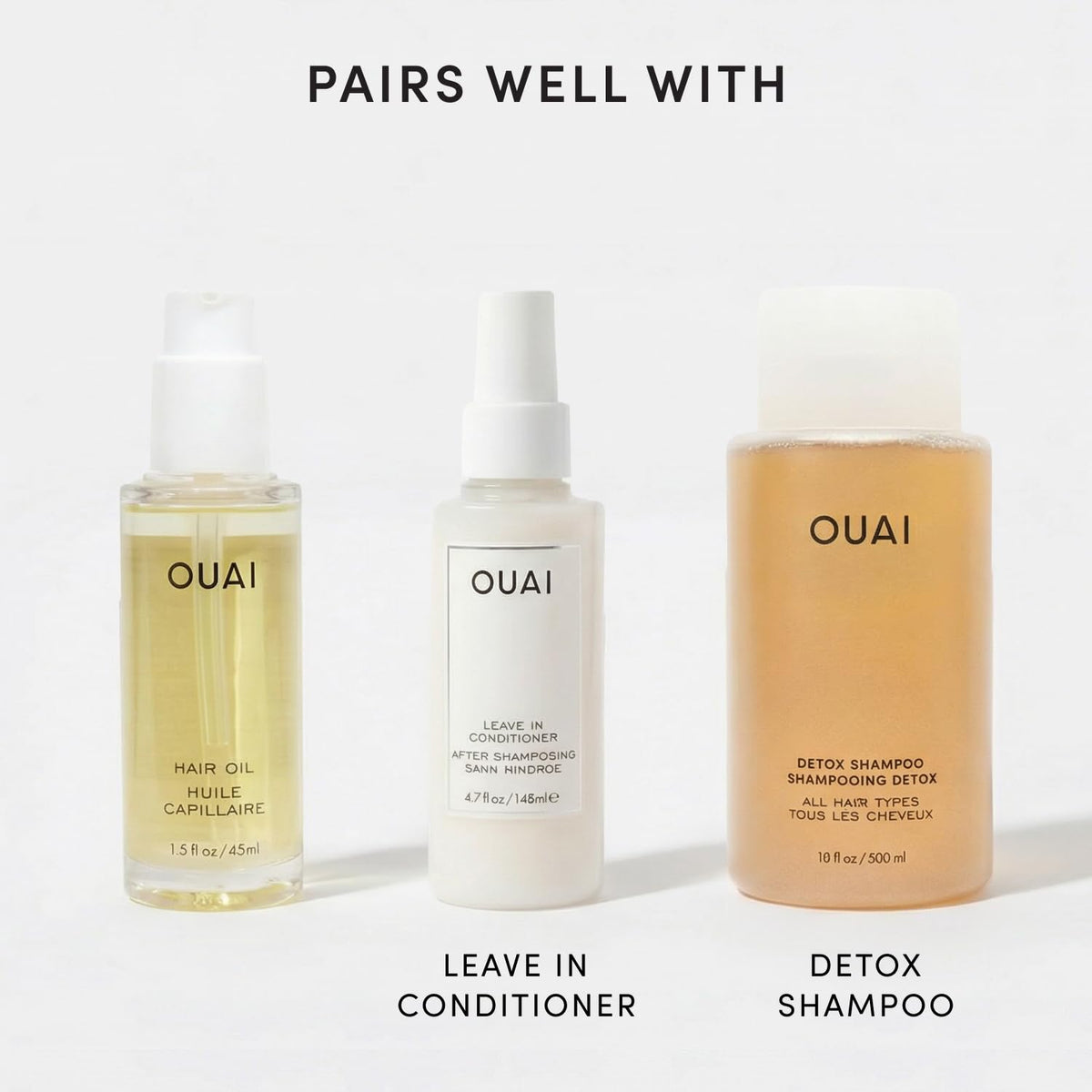 OUAI Hair Oil with background of hair care products