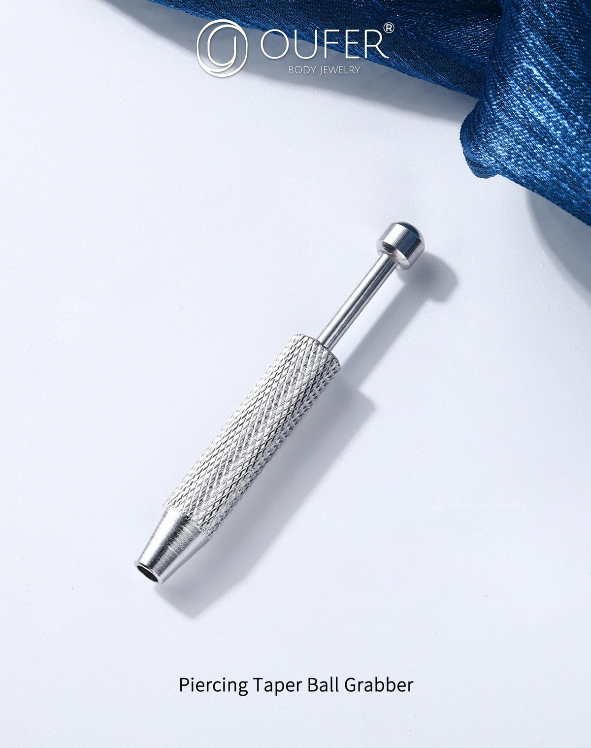 OUFER Piercing Ball Grabber Tool alongside various piercing jewellery