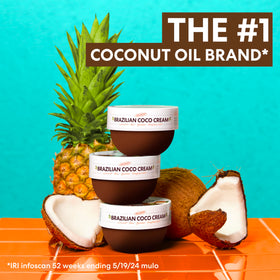 Palmer's Firming Body Cream with fresh coconuts and tropical flowers