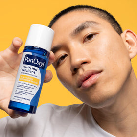 PanOxyl Clarifying Exfoliant displayed with natural elements