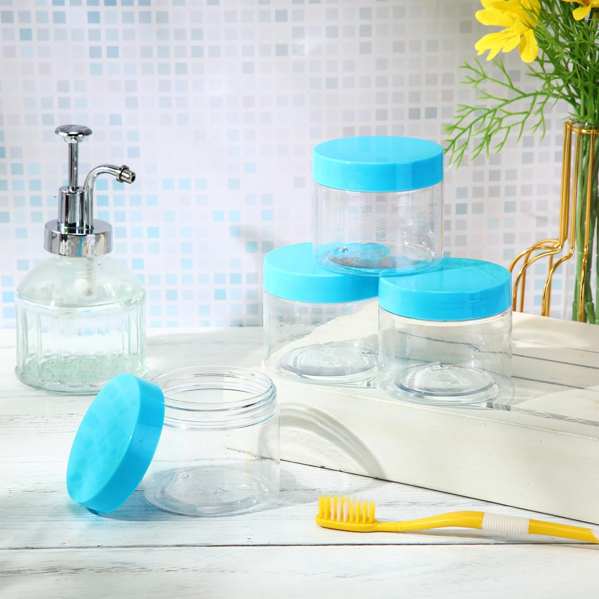 Patelai plastic jars with blue lids on a white background
