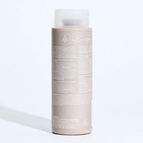 Paul Mitchell The Detangler Conditioner on a vanity table