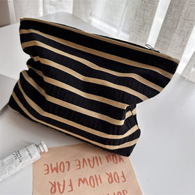 PAZIMIIK Flat Makeup Bag on a table with beauty products