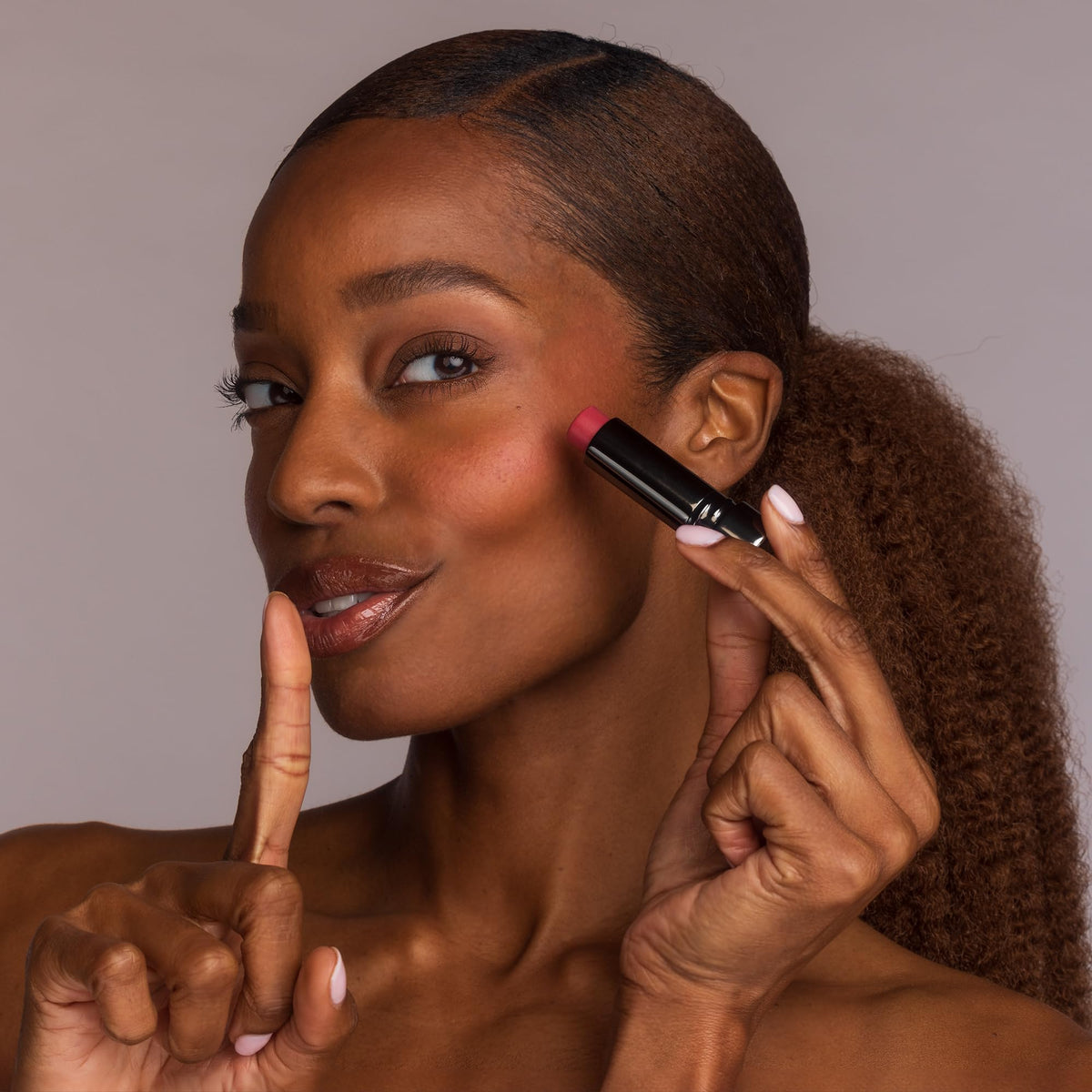 Perricone MD No Makeup Blush Balm on a vanity with other makeup products