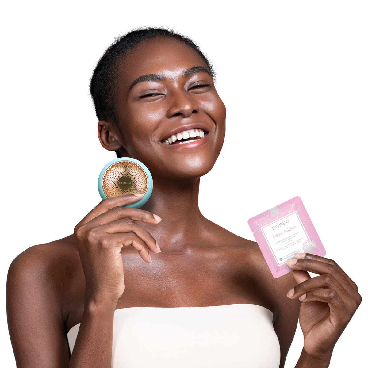 Person applying FOREO Glow Addict Facial Mask at home