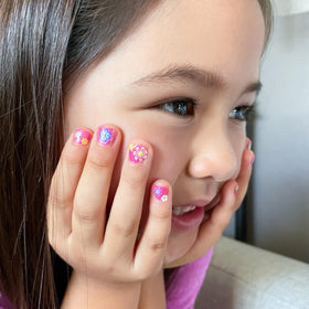 Piggy Paint Shimmery Pink Nail Polish on display with accessories