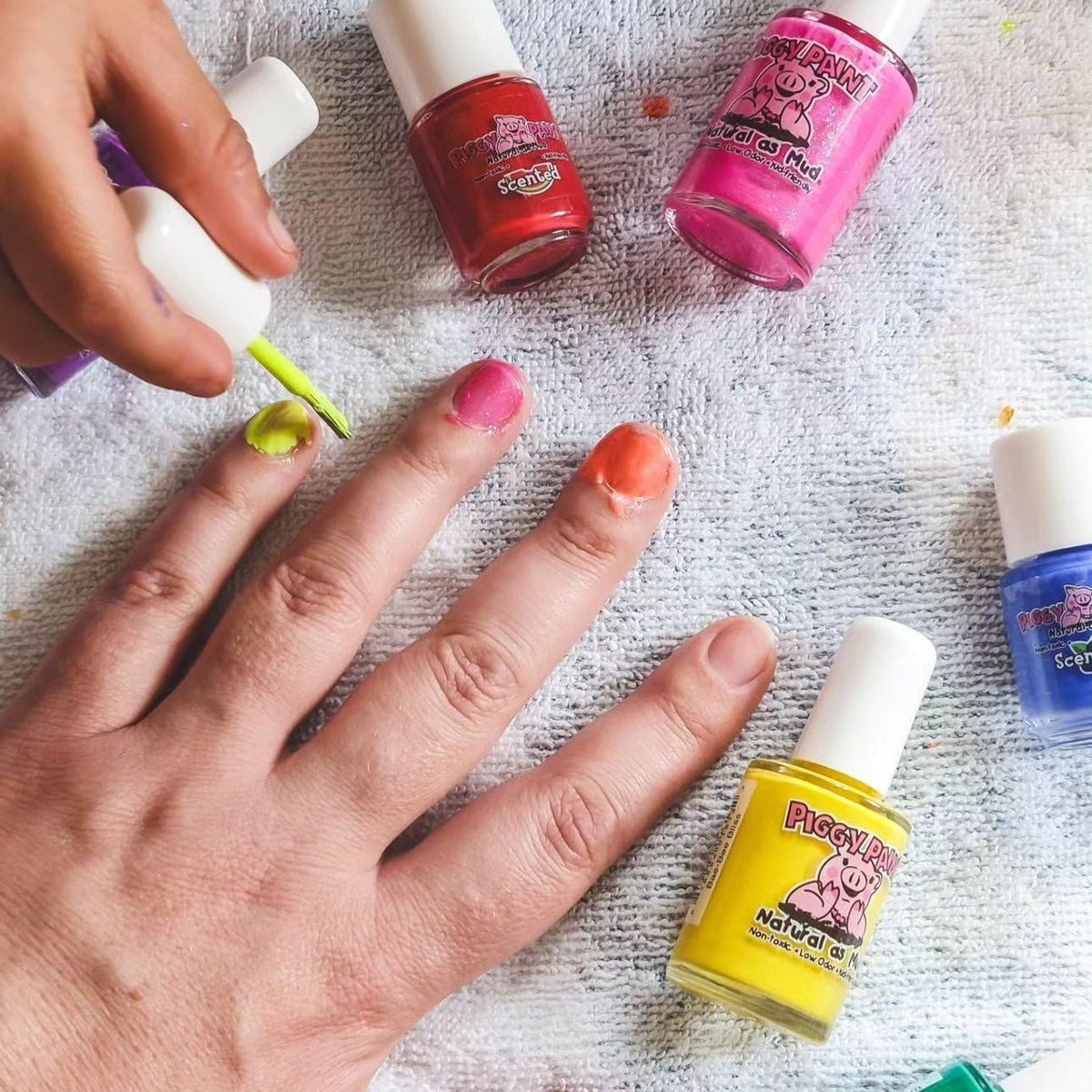 Piggy Paint Sunshine Yellow nail polish on a child's nails