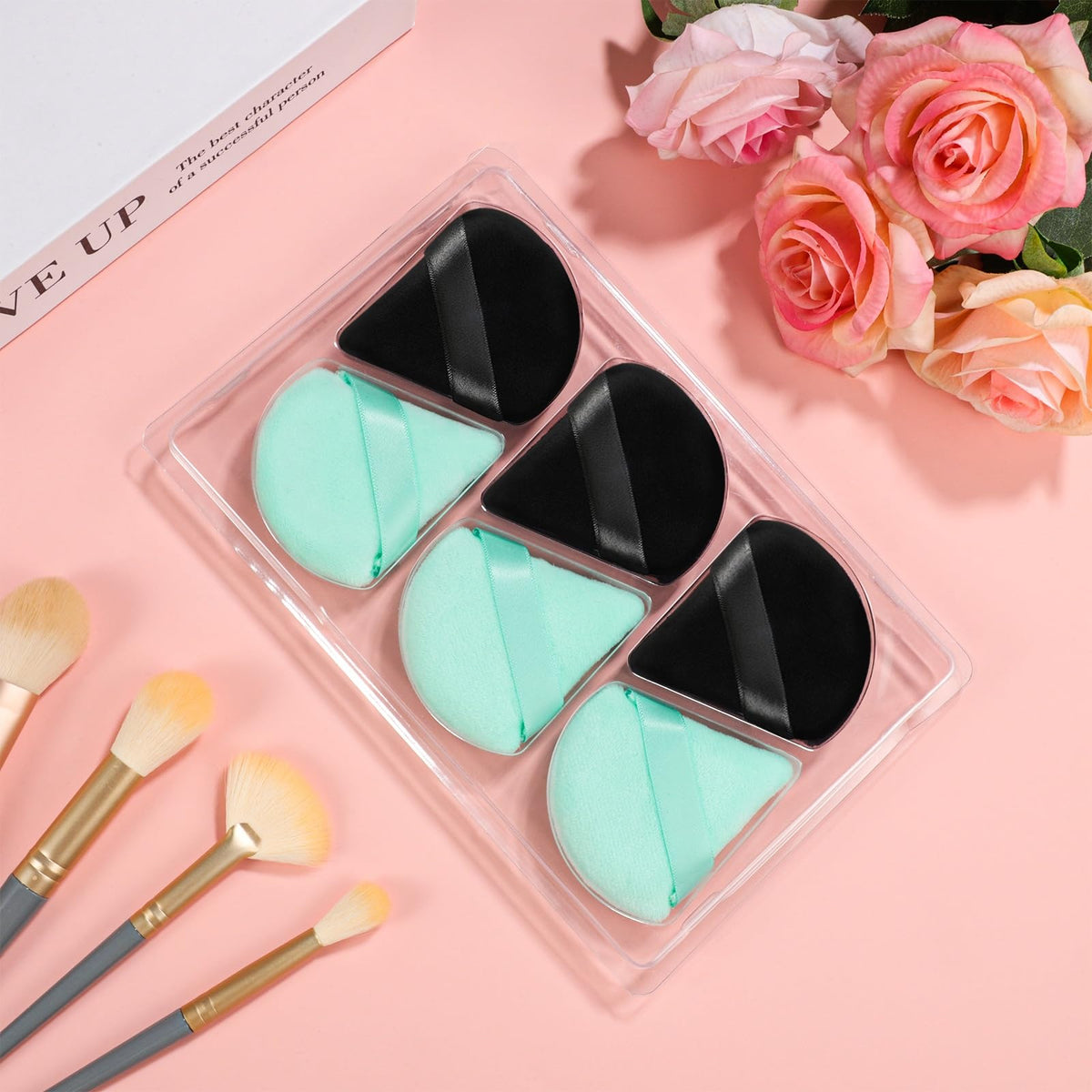 Pimoys Triangle Powder Puff in hand demonstrating size and grip