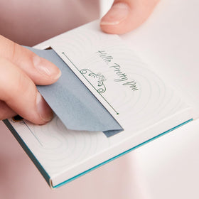 PleasingCare Large Face Oil Blotting Sheets held in hand