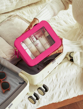Popvibe Clear Makeup Bag on a travel suitcase