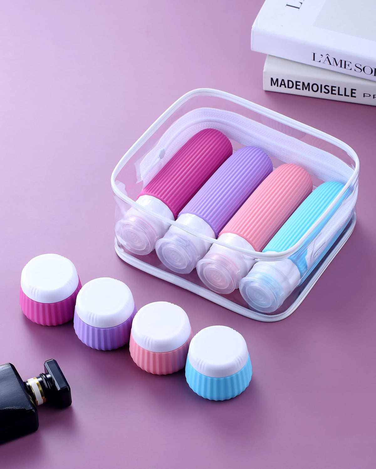 Portable clear makeup bag containing travel bottles and jars