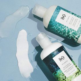 R+Co Atlantis Shampoo and Conditioner Set on bathroom shelf