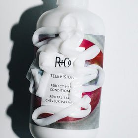 R+Co Television Perfect Hair Conditioner 33.8 oz in bathroom setting