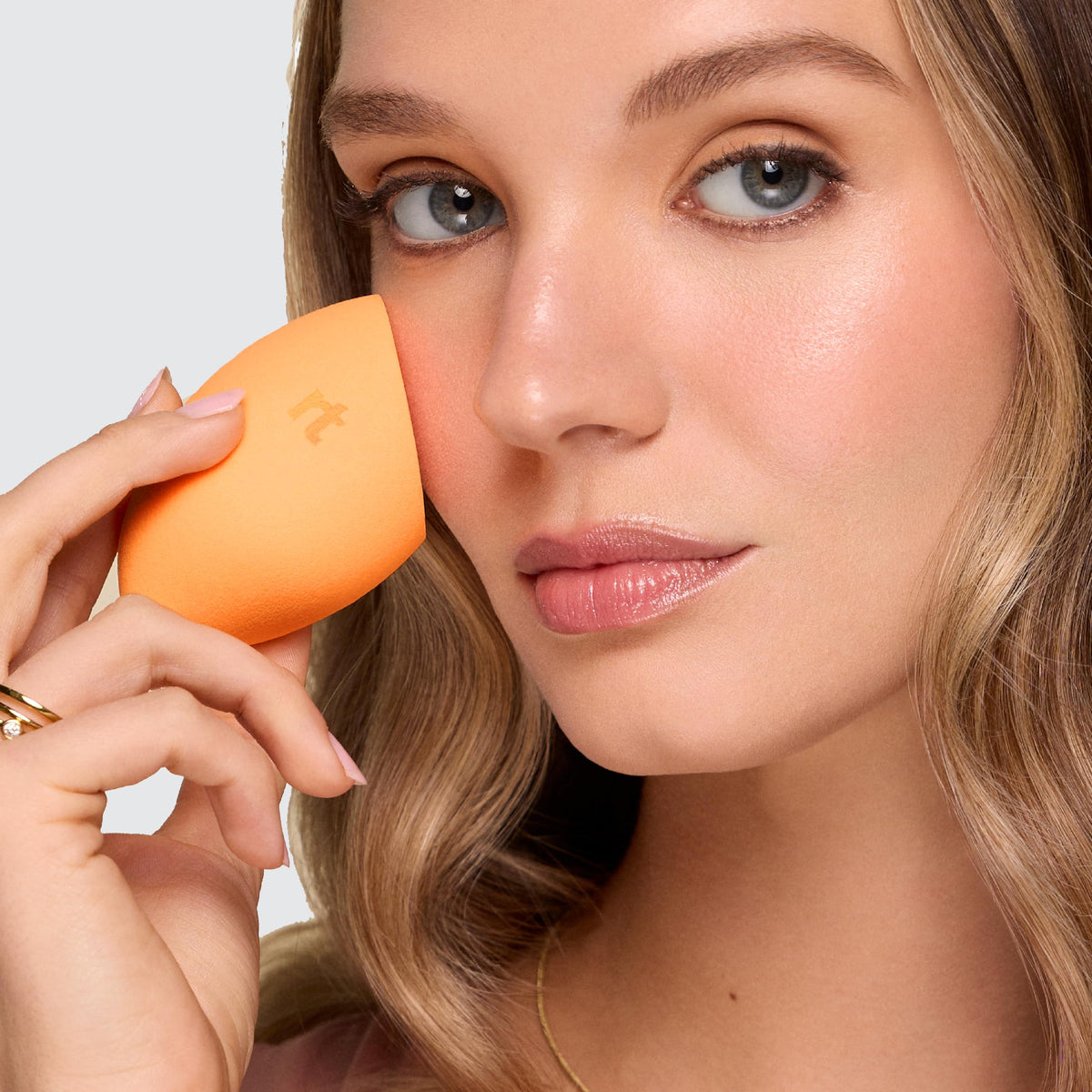 Real Techniques Miracle Complexion Sponge Duo on a vanity with makeup products