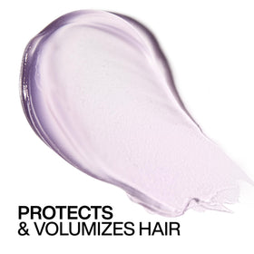 Redken Big Blowout Heat Protectant Gel on a vanity with styling tools