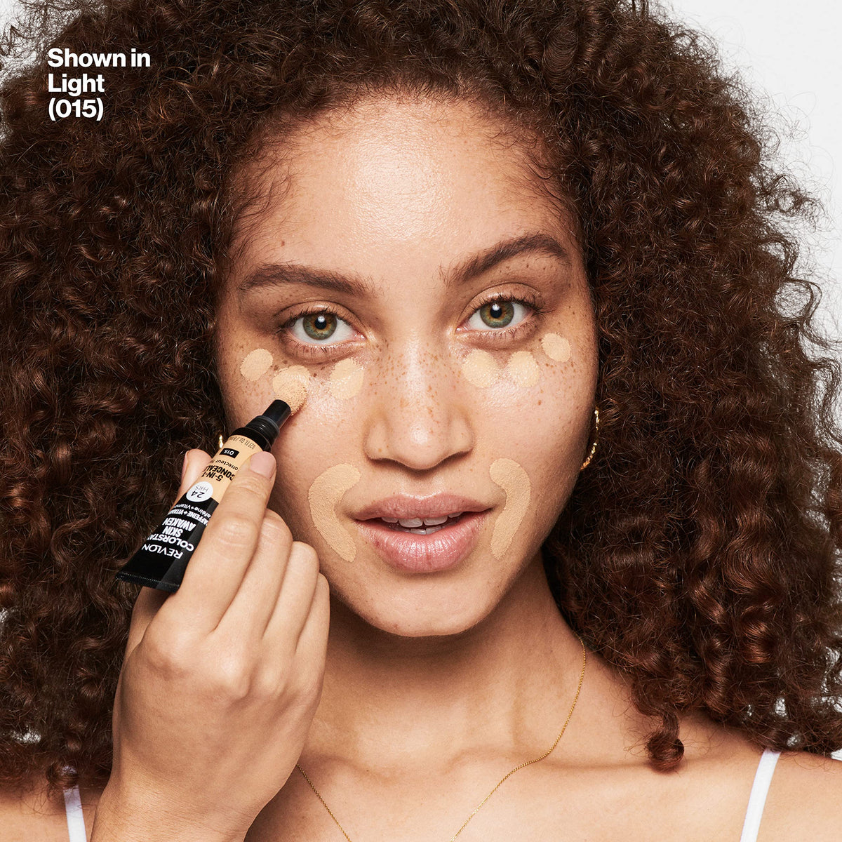 REVLON ColorStay Skin Awaken Concealer 015 Light displayed with makeup tools