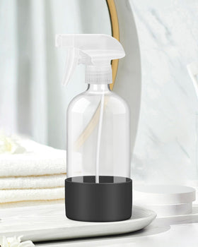 Rionisor glass spray bottle in use for misting plants