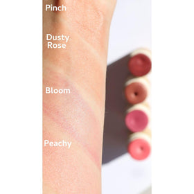 River Organics Cream Blush Stick in hand with natural background