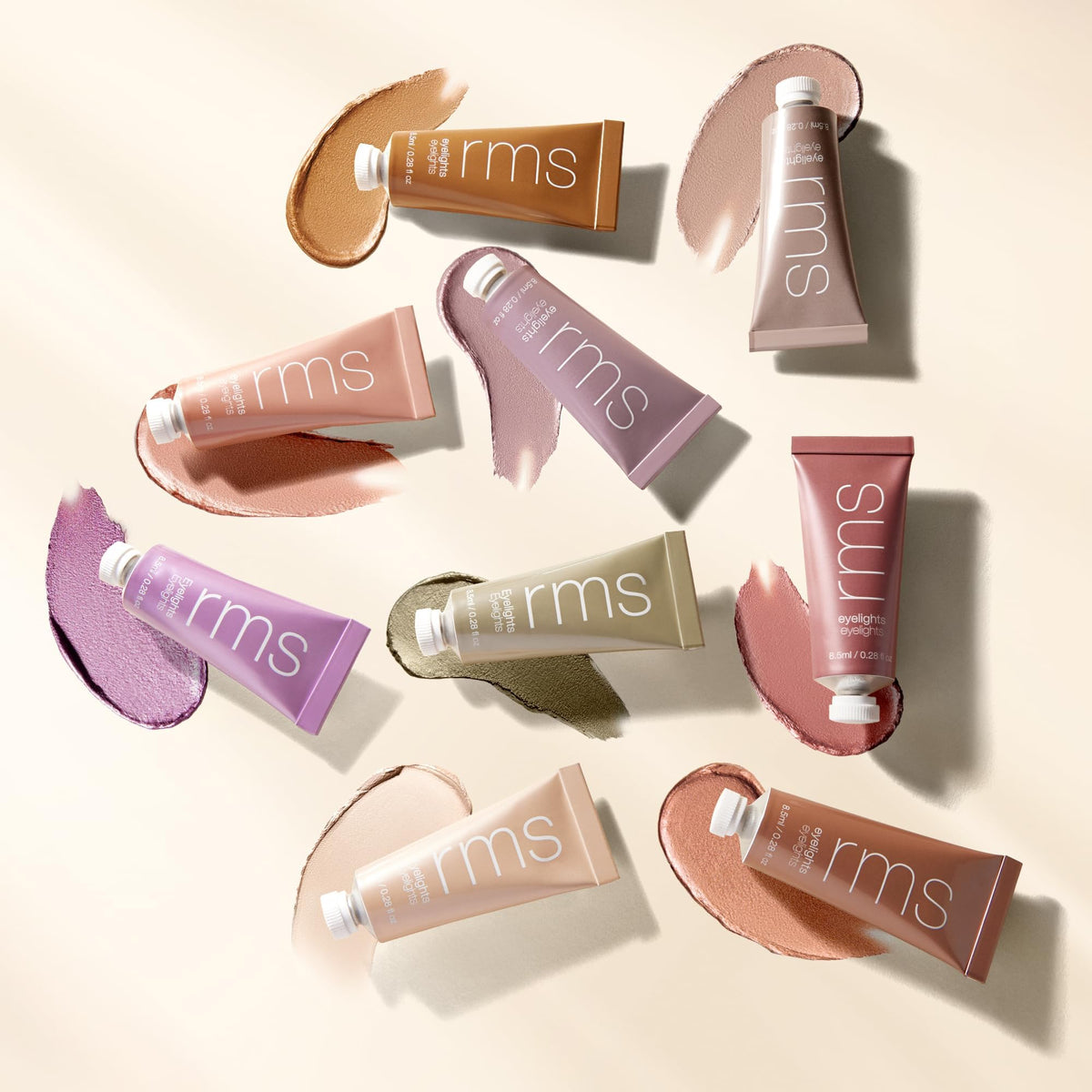RMS Beauty Eyelights Cream Eyeshadow displayed with makeup brushes