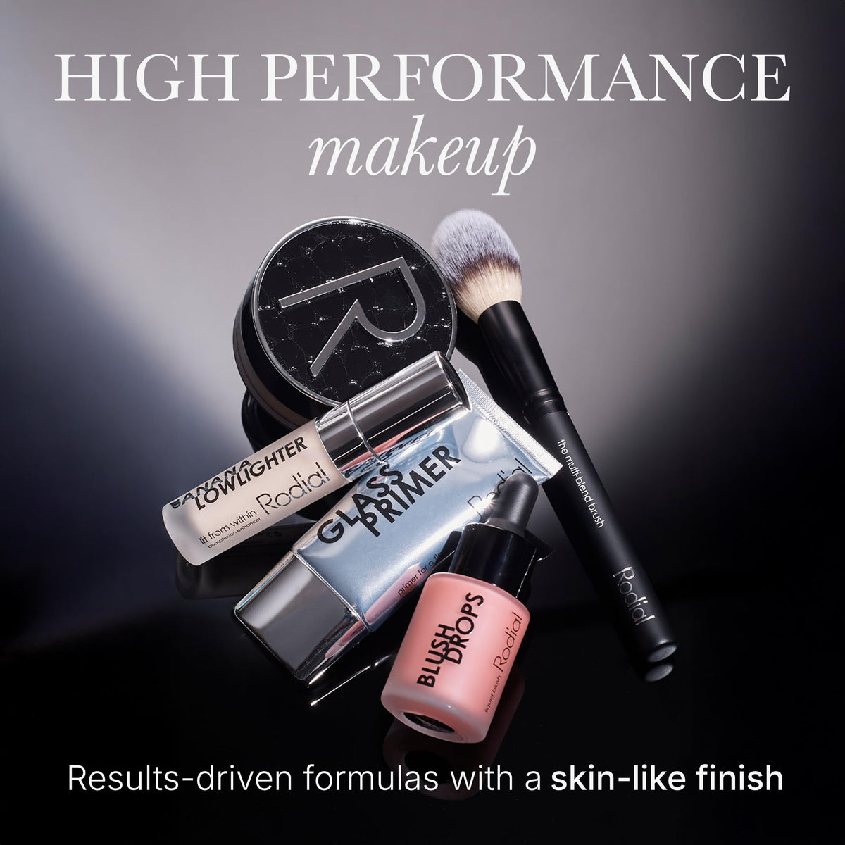 Rodial Soft Focus Glow support Drops on a vanity with flowers