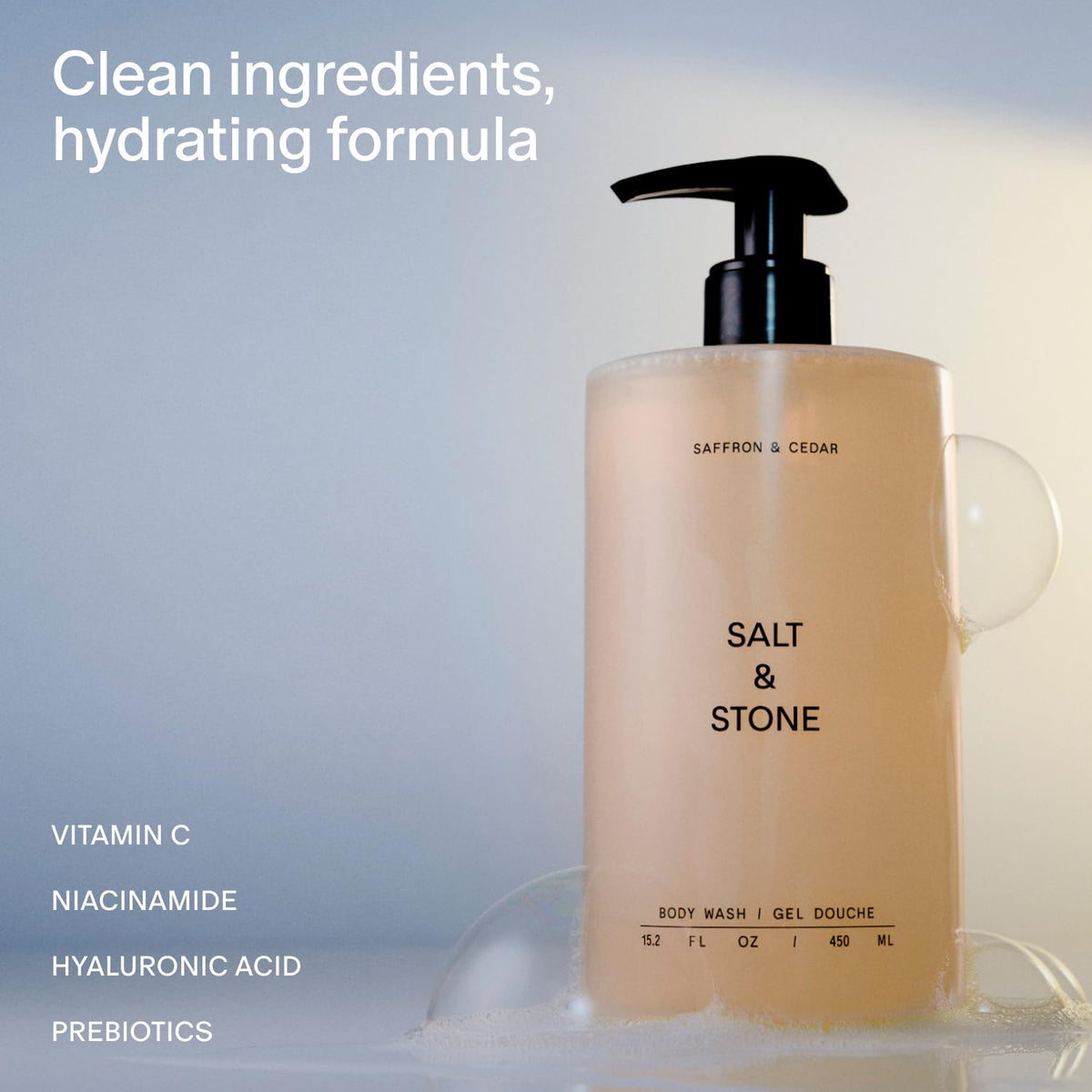 Salt & Stone Body Wash Saffron & Cedar bottle with lather
