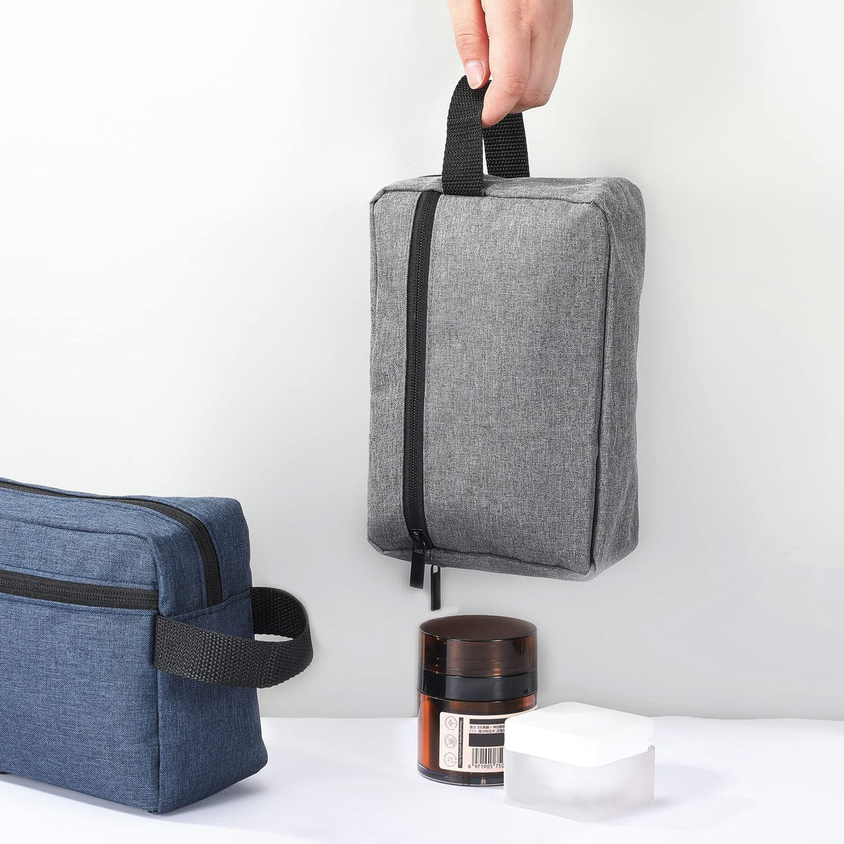 Sanwuta toiletry bag in grey hanging on a hook
