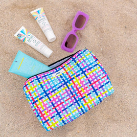 SCOUT Packin' Heat Cosmetic Bag lifestyle scene on travel setup