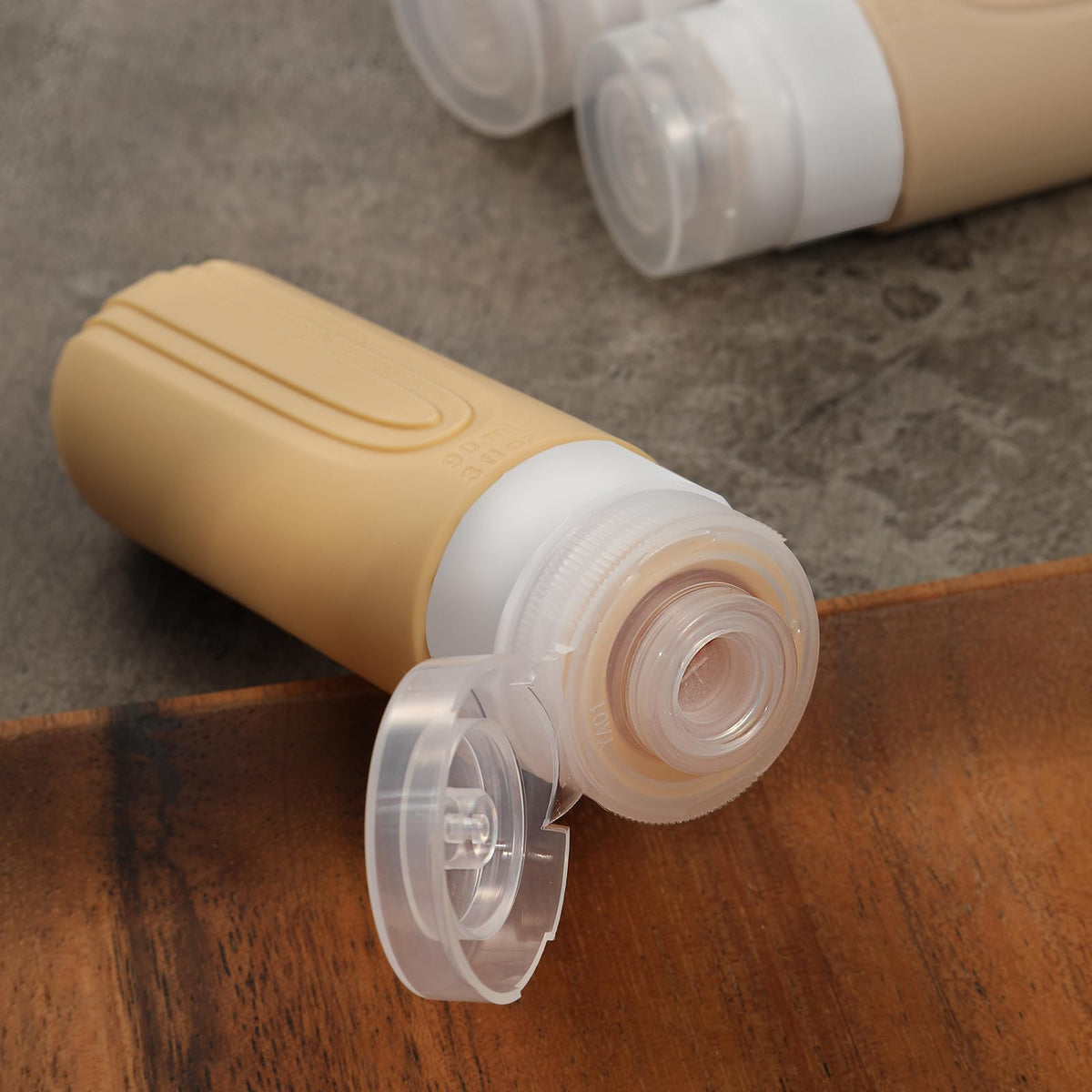 Side view of CHEODIN Travel Bottles with labels