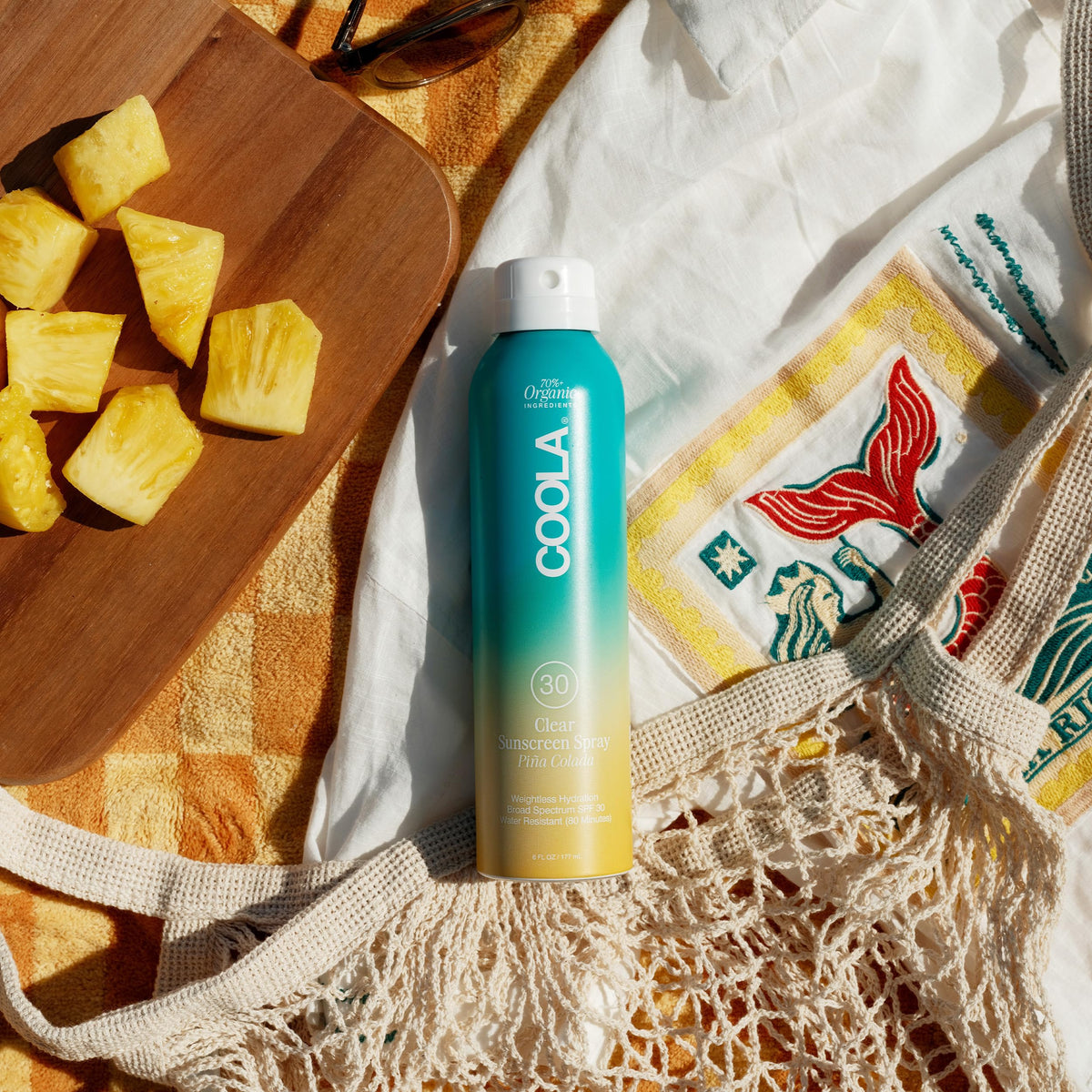 Side view of COOLA Organic Sunscreen SPF 30 Spray bottle