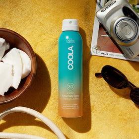 Side view of COOLA Organic Sunscreen SPF 30 Tropical Coconut Spray