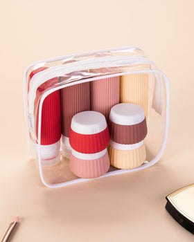 Silicone travel bottles and jars on a travel backdrop